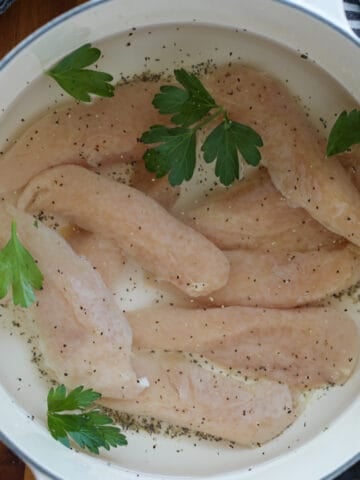 boiled chicken tenders before cooking in a pot on the stovetop