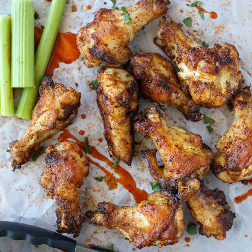 cajun dry rub chicken wings in the oven on a white background