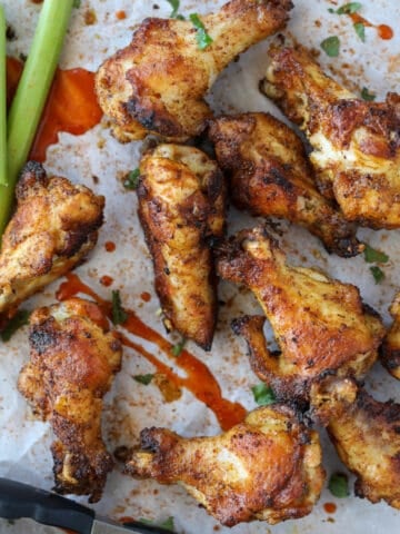 cajun dry rub chicken wings in the oven on a white background