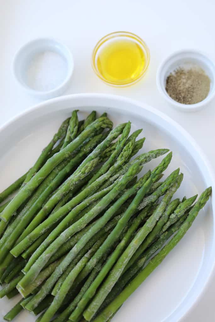 roasted frozen asparagus air fryer recipe ingredients on a white tray