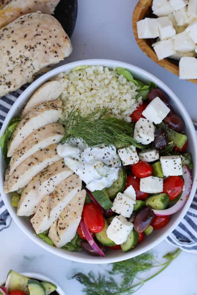 greek salad bowl with chicken in a white bowl