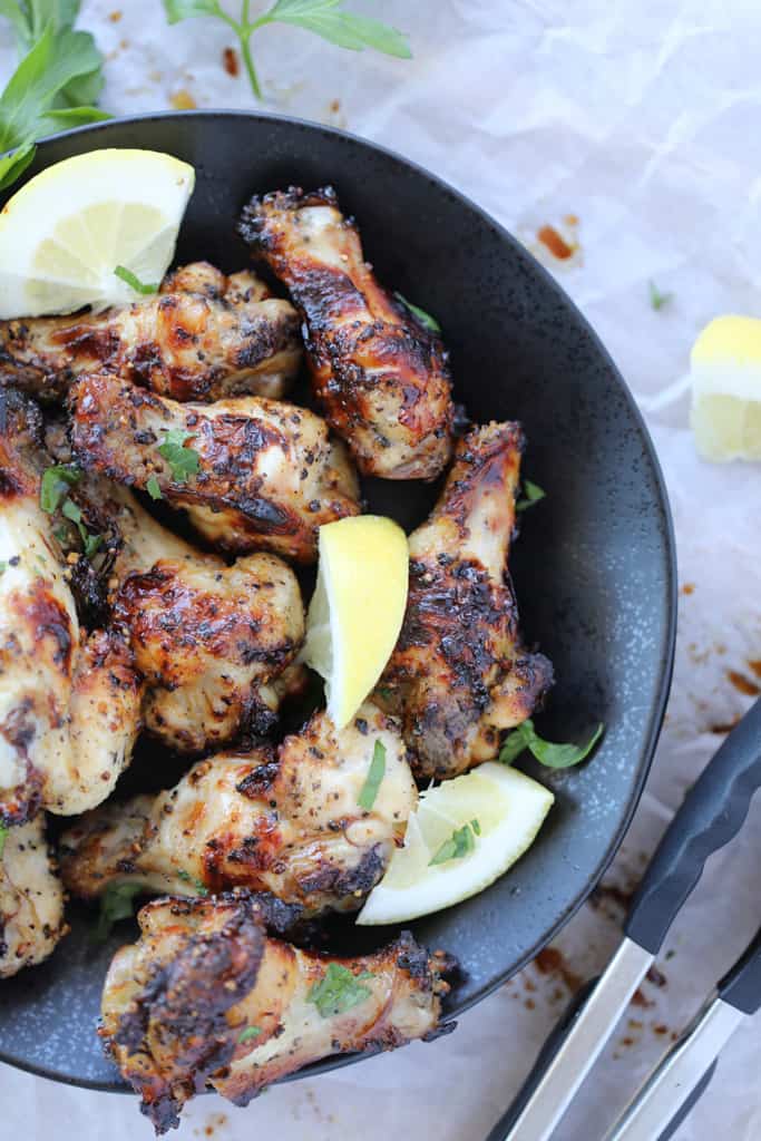 lemon pepper air fryer wings on a black plate