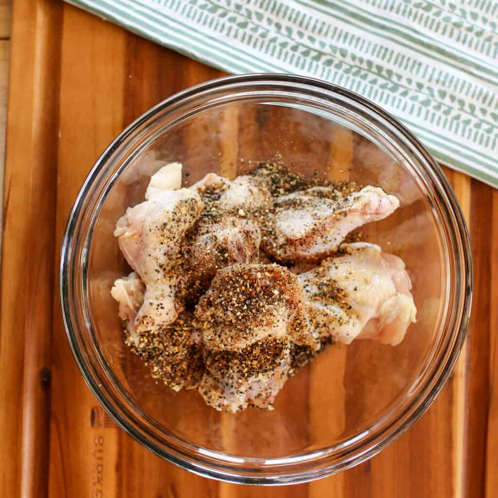 lemon pepper wings in air fryer ingredients in a bowl to mix