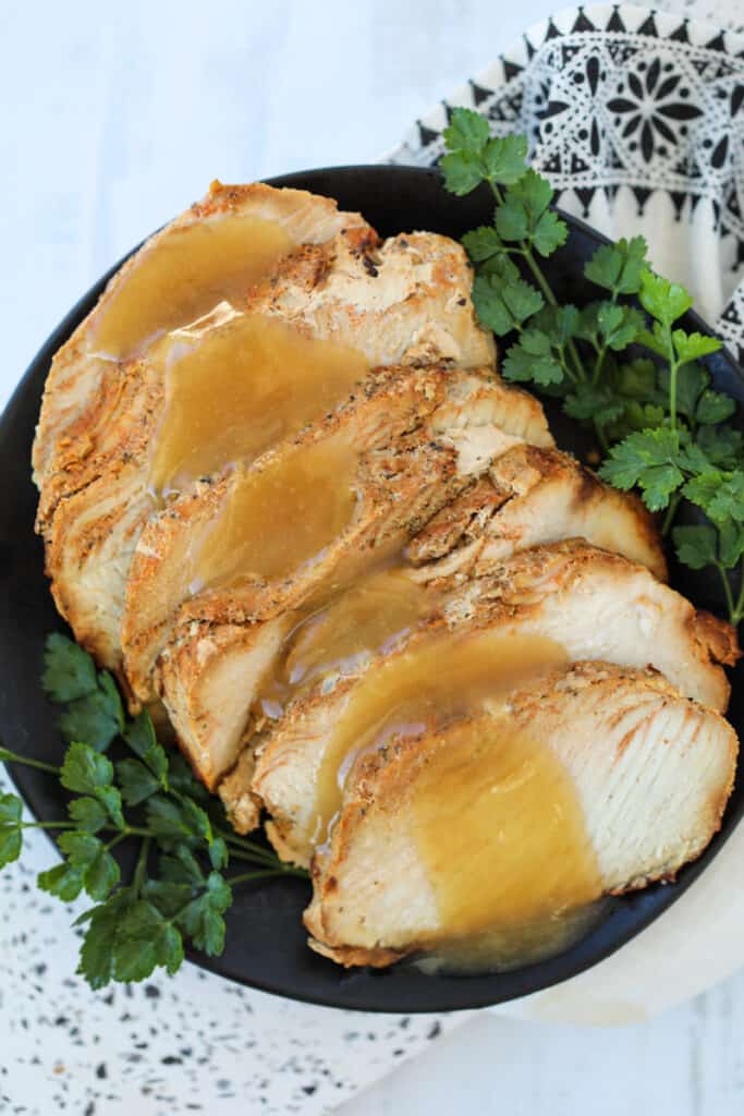 air fryer boneless turkey breast roast with gravy on a serving plate