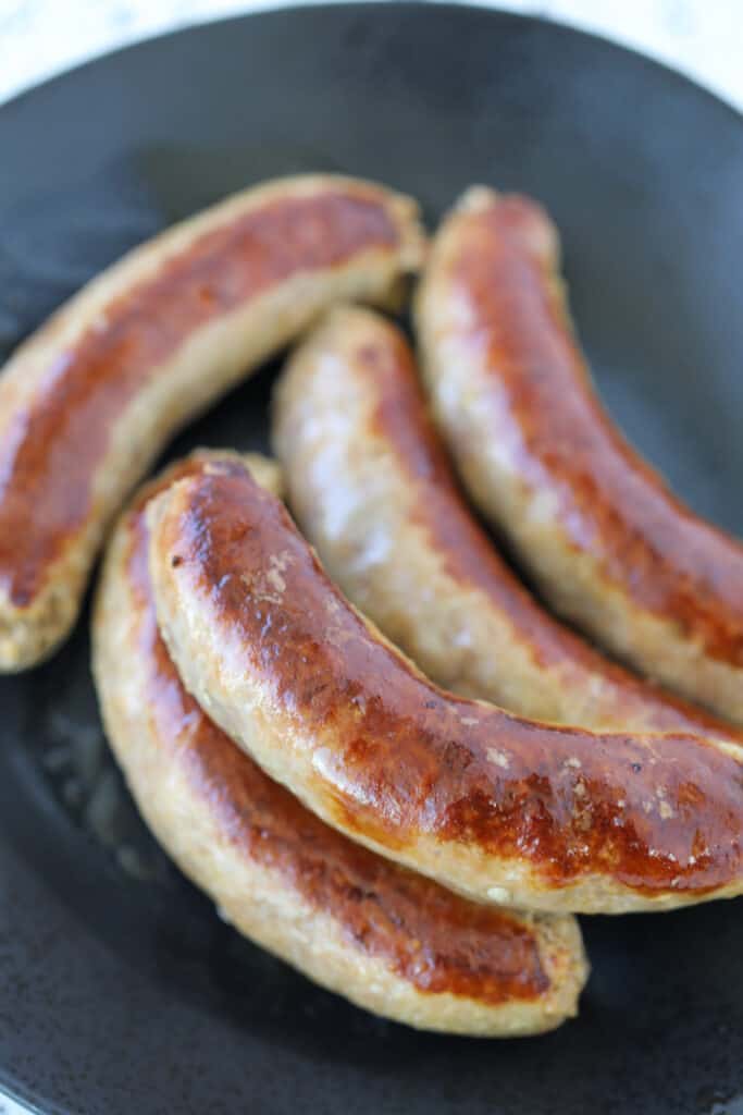 instant pot Italian sausage on a black plate after pressure cooking