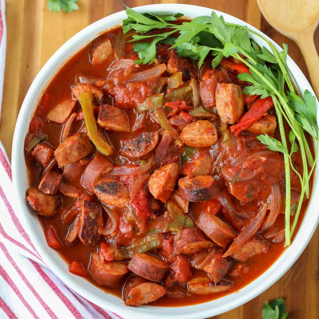 slow cooked kielbasa in a white bowl after cooking in a crockpot