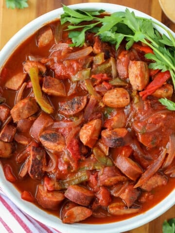 slow cooked kielbasa in a white bowl after cooking in a crockpot