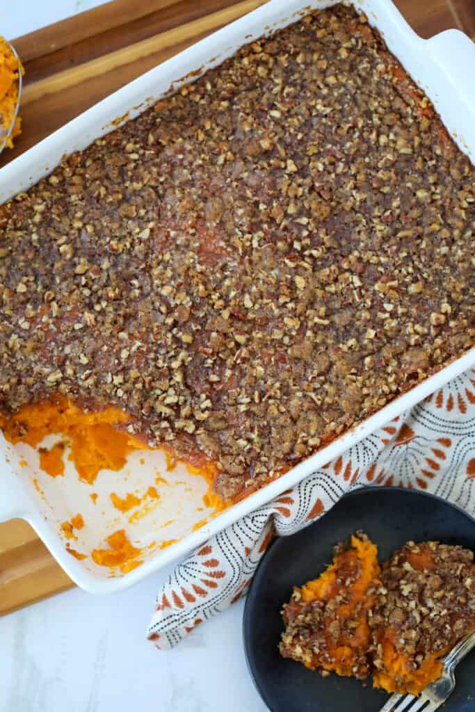the sweet potato casserole instant pot recipe with a serving scooped out of the baking dish
