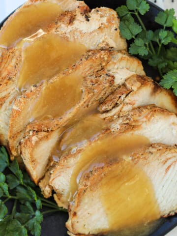 boneless turkey breast in air fryer sliced on a serving plate