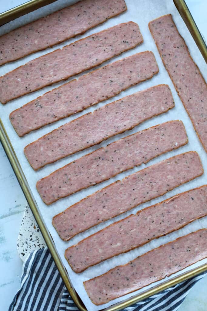 turkey bacon oven starts by laying the cold precooked turkey on a baking sheet