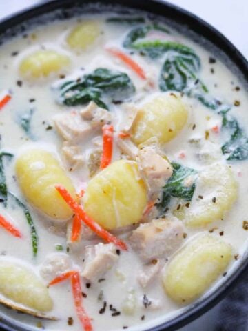 chicken gnocchi soup instant pot recipe close up photo in a black bowl