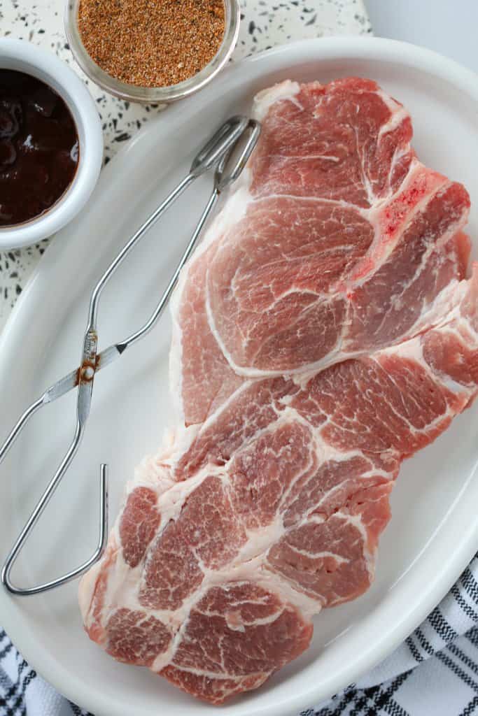 air fryer pork steaks ingredients on a white tray