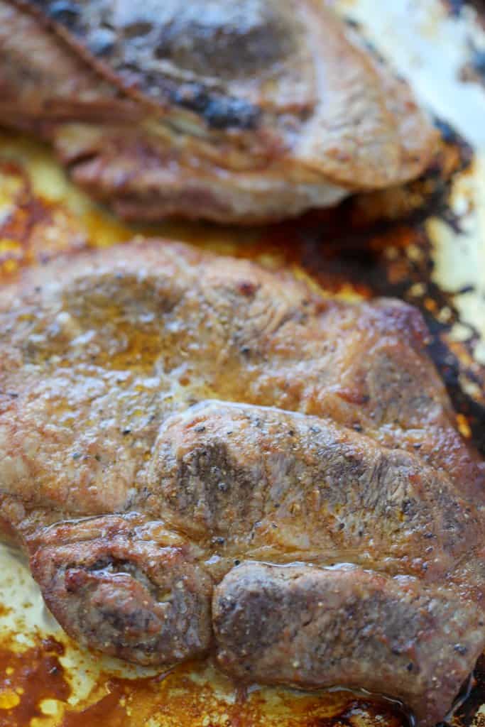 juicy baked pork steaks in the oven before adding sauce