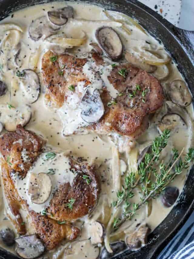 pork shoulder blade steak cooked in a skillet with mushroom and onion sauce