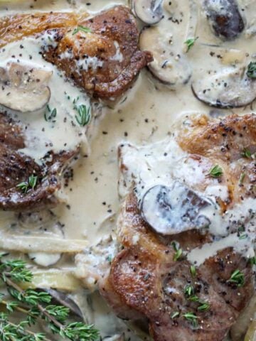 pan fried pork steak with gravy drizzled over the top