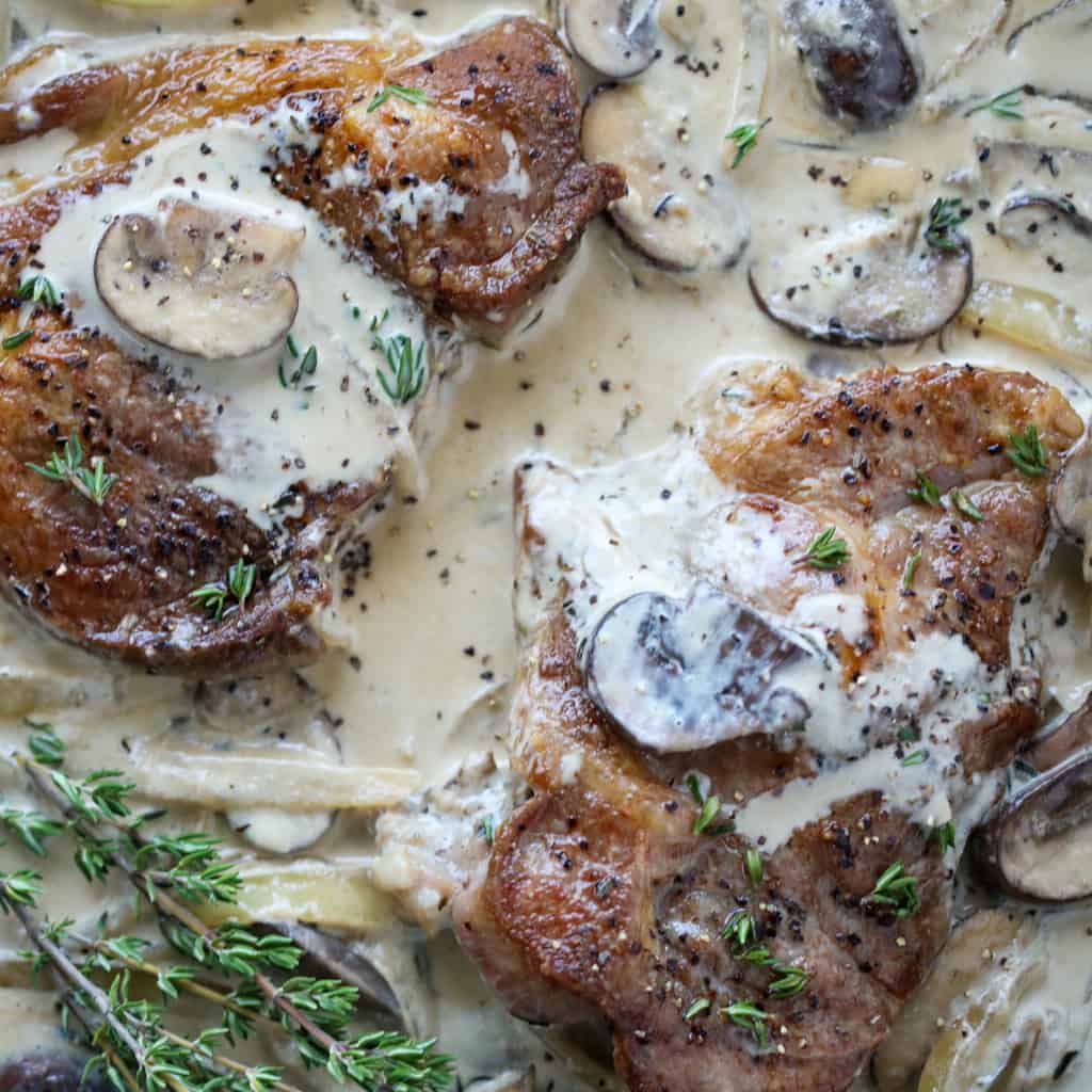 pan fried pork steak with gravy drizzled over the top