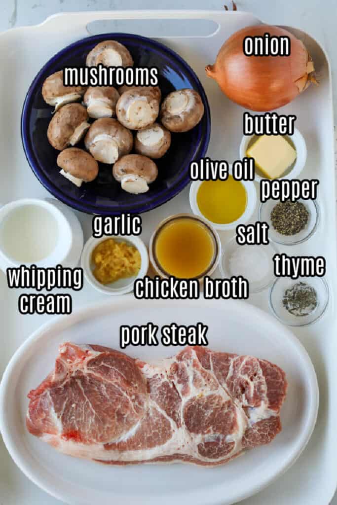smothered pork steak recipes ingredients on a white tray