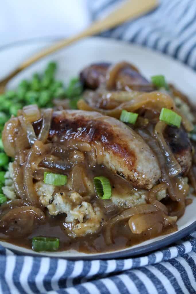 irish bangers and mash served with stout onion gravy on a white plate