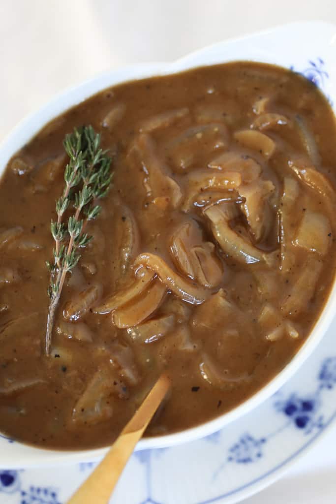 bangers and mash gravy in a white gravy boat