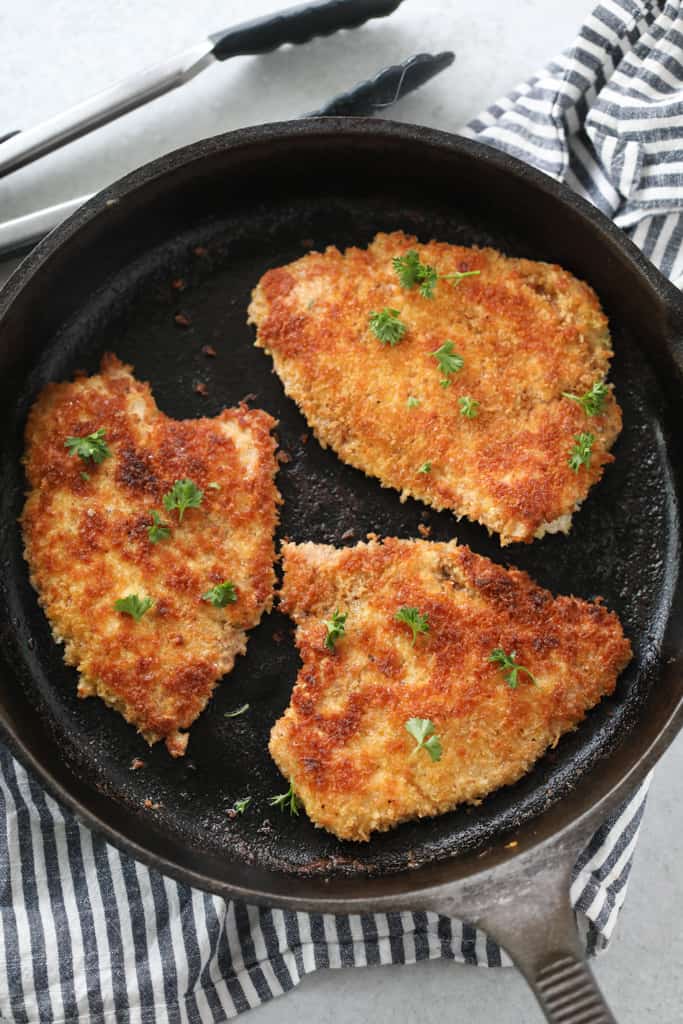 crispy breaded turkey cutlets in a skillet
