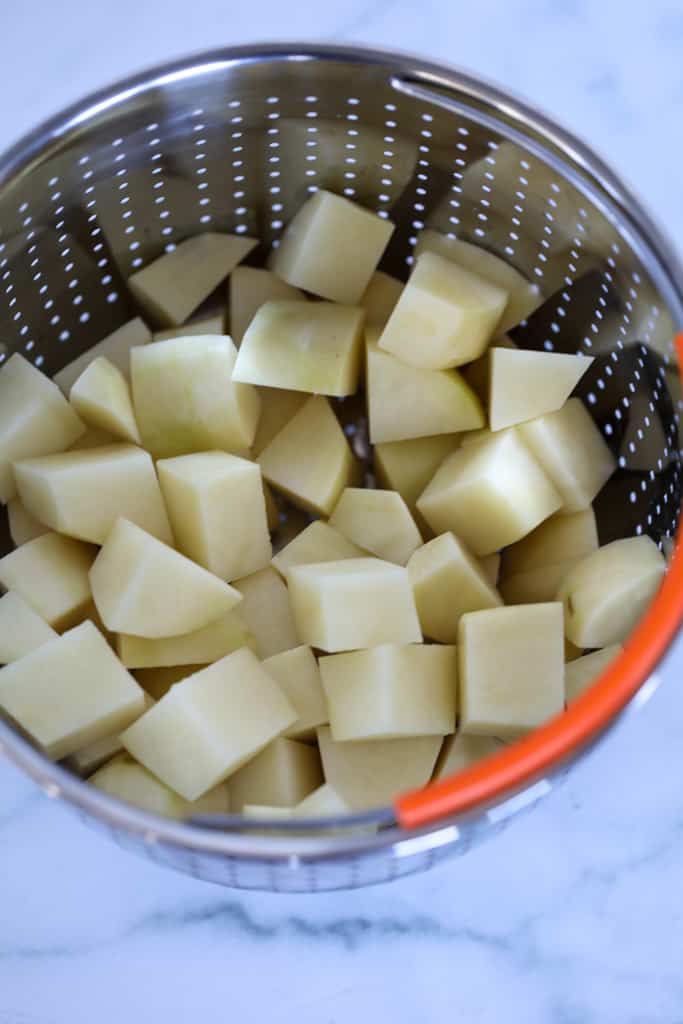 instant pot diced potatoes raw in a collander