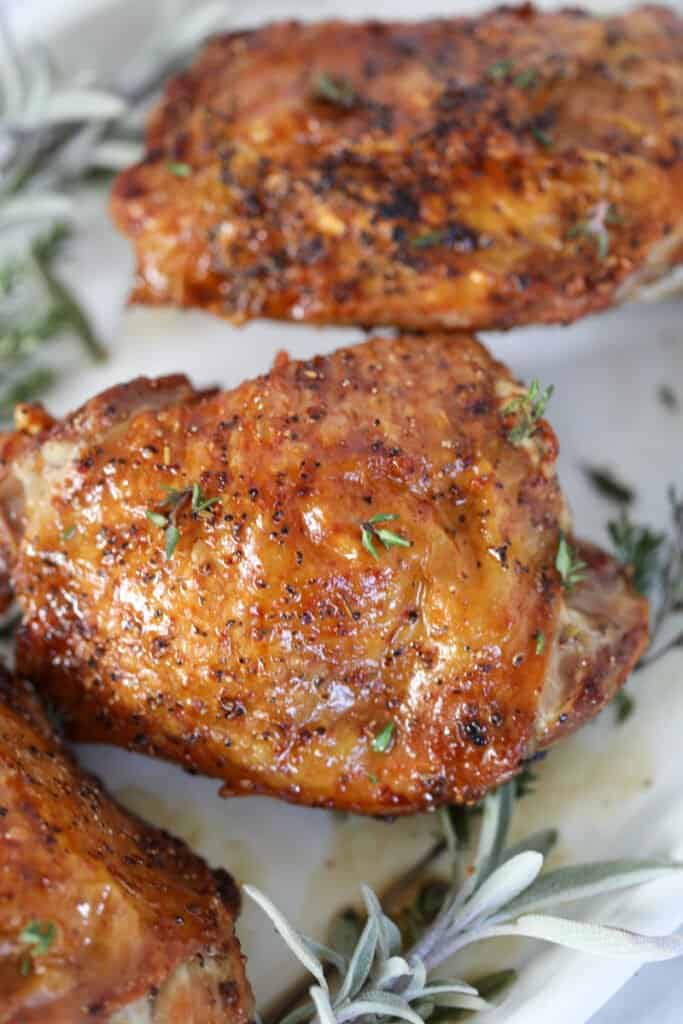 the best turkey thighs in air fryer recipe with sauce on a white plate