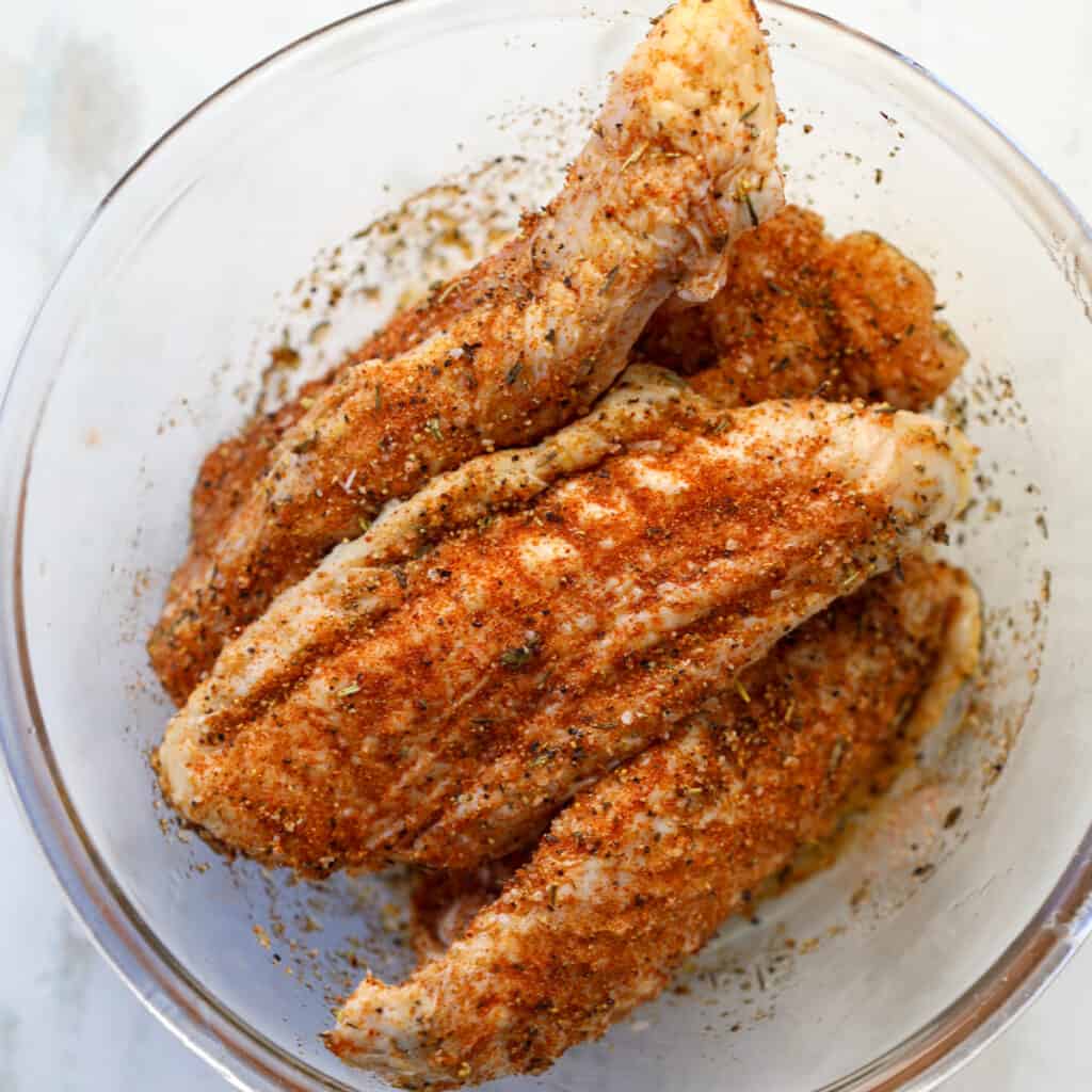 cooking turkey wings air fryer recipe starts with adding seasoning in a bowl