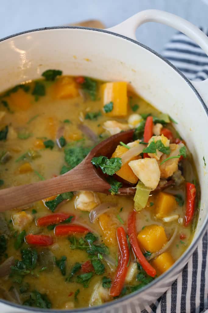 curried cod in a white dutch oven