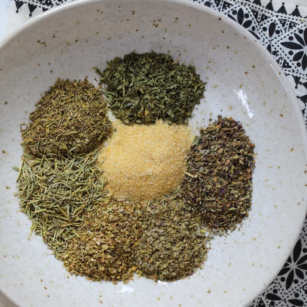 diy italian seasoning recipe individual ingredients on a white plate