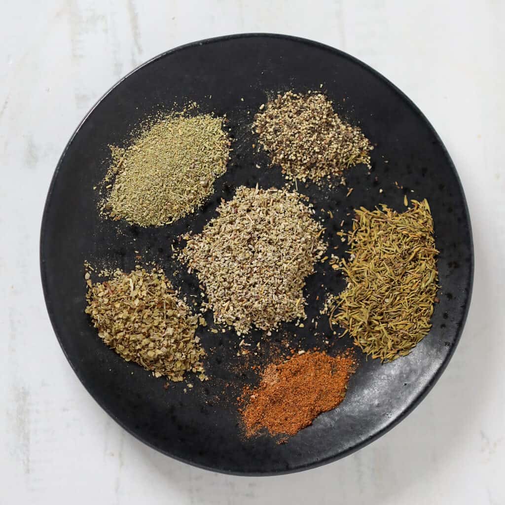 diy substitute for poultry seasoning to make at home on a black plate