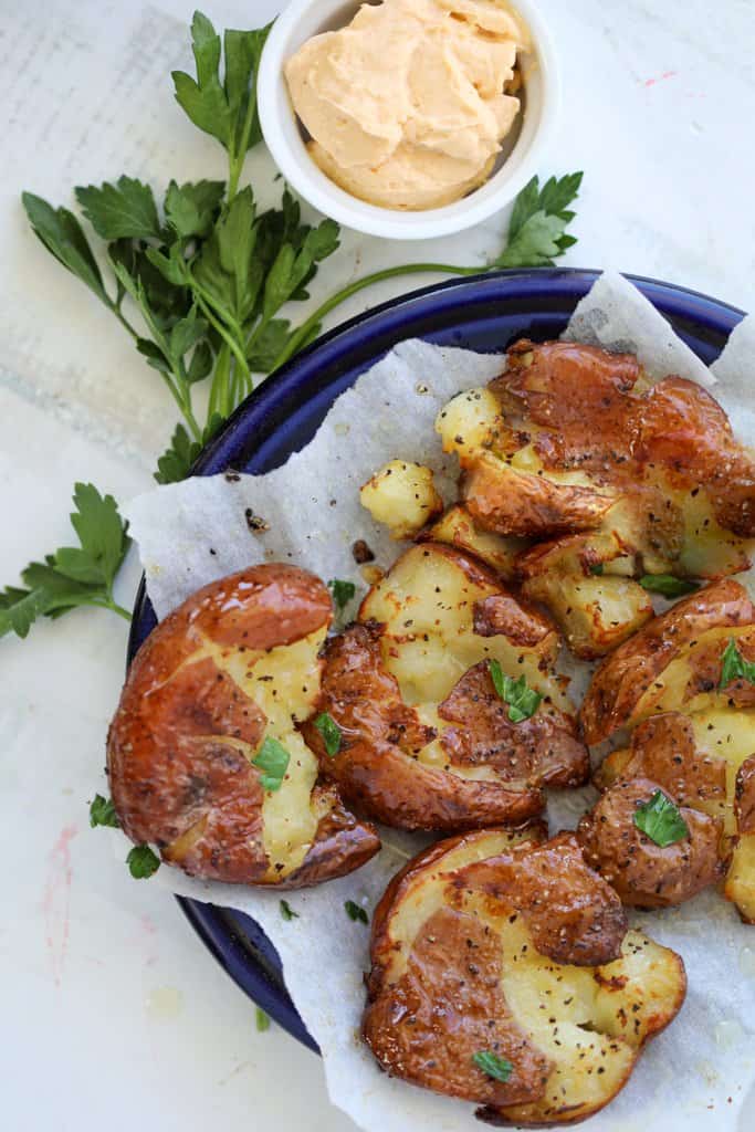 air fryer smashed potatoes on a plate with a side dip 1