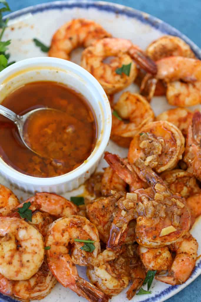 air fryer shrimp old bay recipe on a plate served with garlic butter sauce
