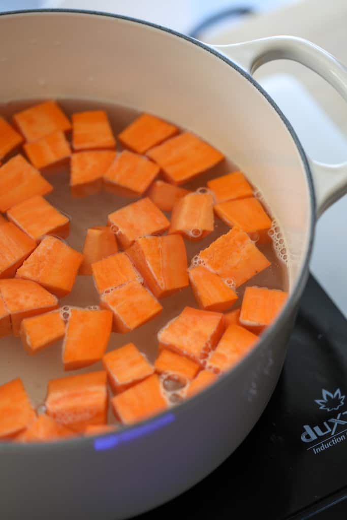 boiling sweet potatoes for mashed sweet potatoes in a bowl