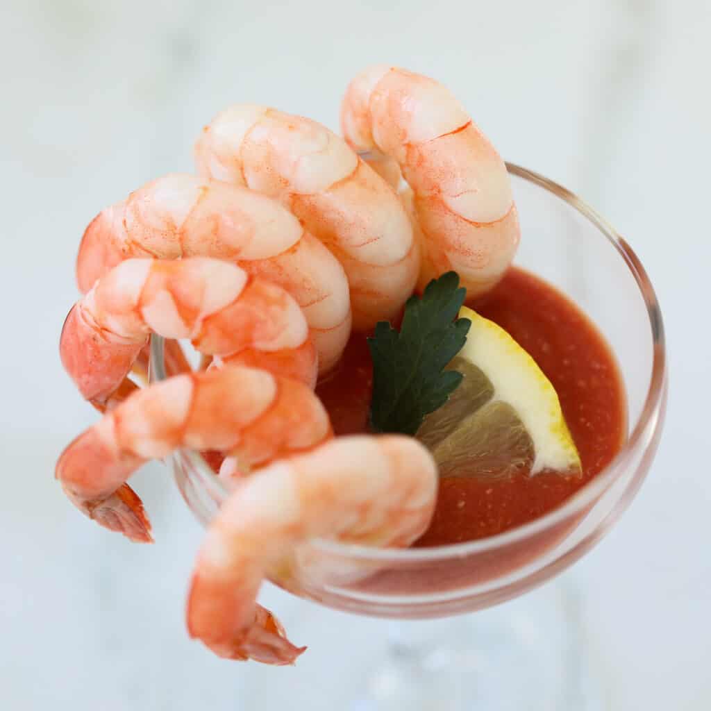 low carb cocktail sauce in a cocktail glass with shrimp on the side