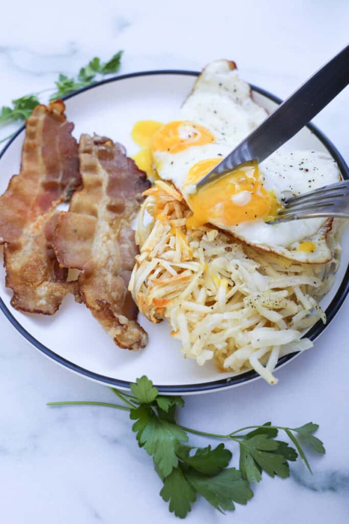 air fryer hash browns shredded and cooked from frozen on a white plate