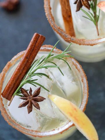 spicy cider margarita close up with rosemary and cinnamon