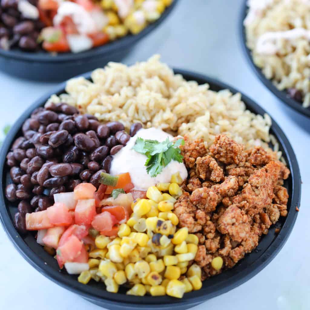 healthy burrito bowl meal prep gets added to each round bowl