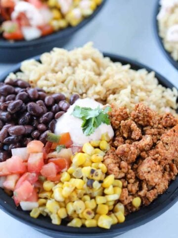 healthy burrito bowl meal prep gets added to each round bowl