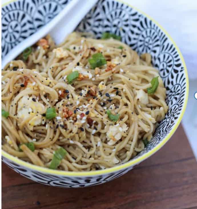 TikTok ramen recipe in a bowl with a spoon ready to eat