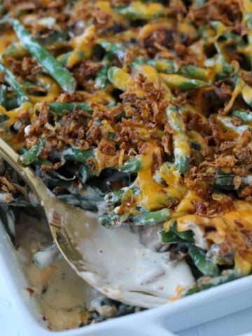 fresh green bean casserole without mushroom soup after baking with a bite out of the casserole