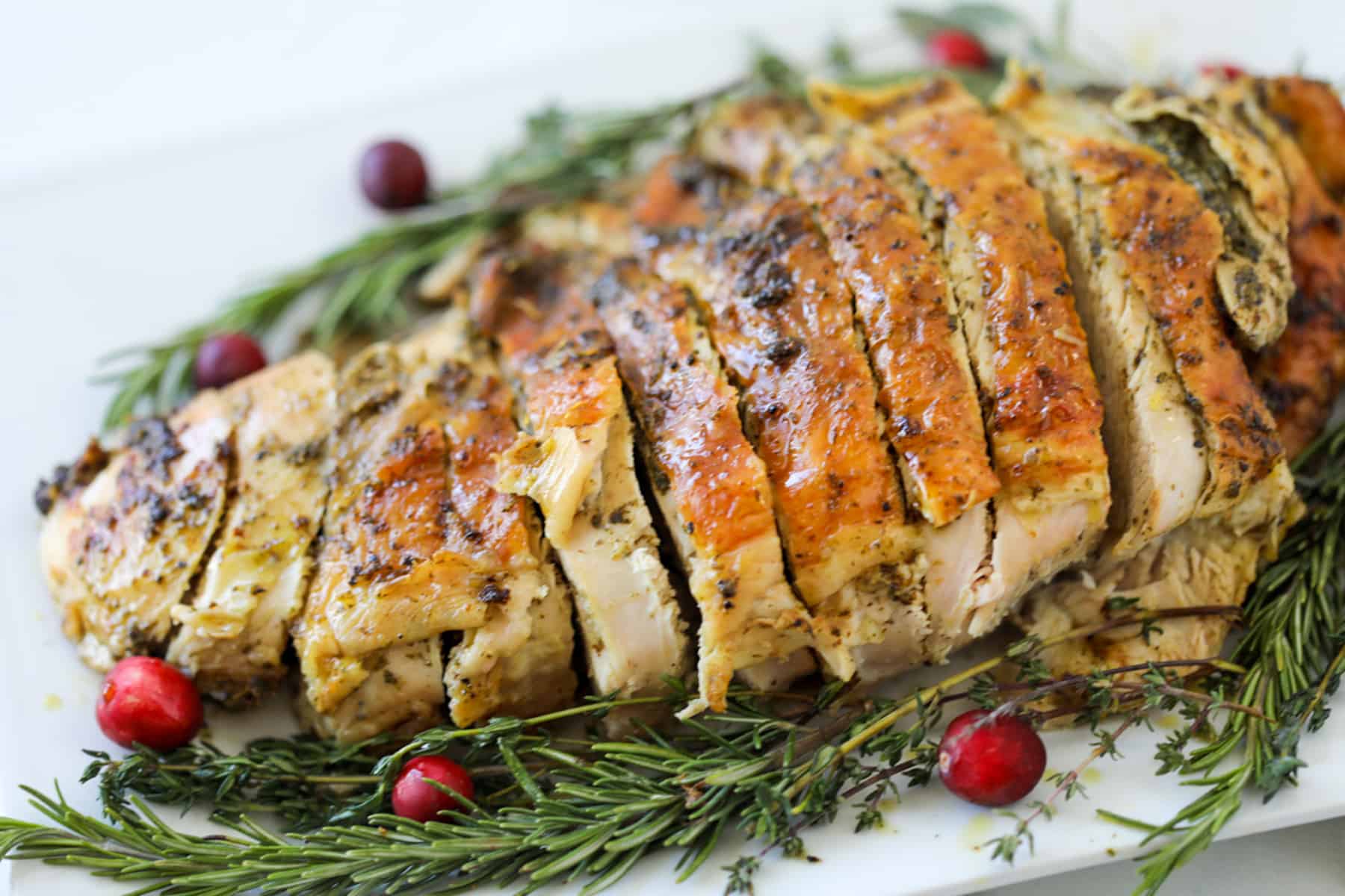 half turkey breast recipe sliced on a plate
