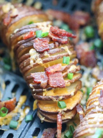 accordion hasselback potatoes in air fryer after cooking in an air fryer basket