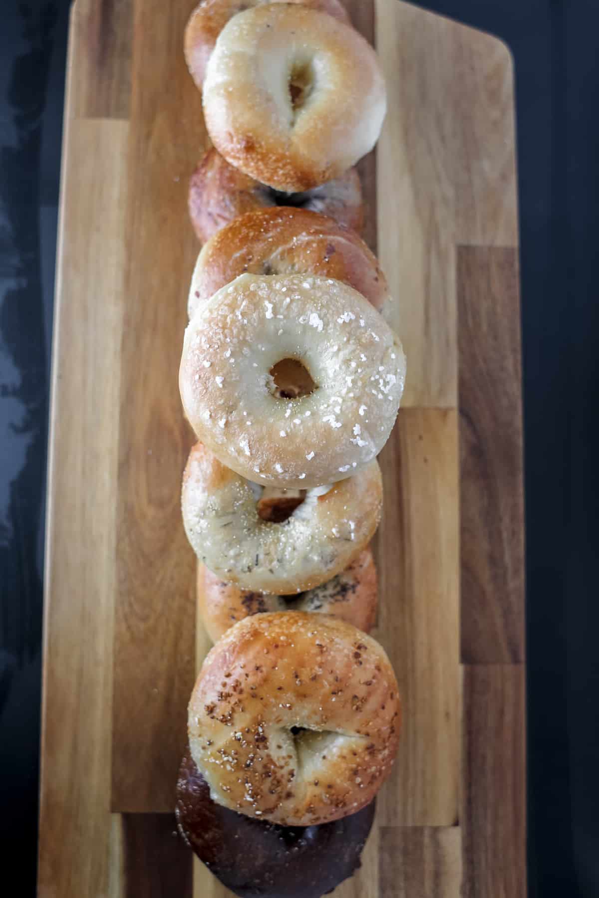 arrange the bagels on the wooden cutting board
