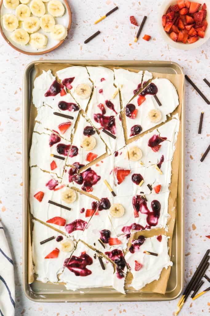 frozen greek yogurt bark on a pan after freezing broken into pieces