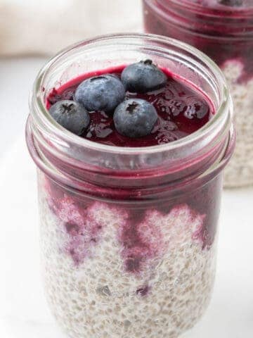 blueberry chia seed pudding assembled in mason jars