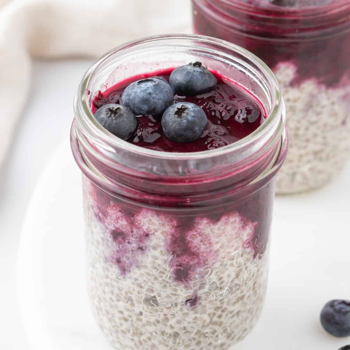 blueberry chia seed pudding assembled in mason jars