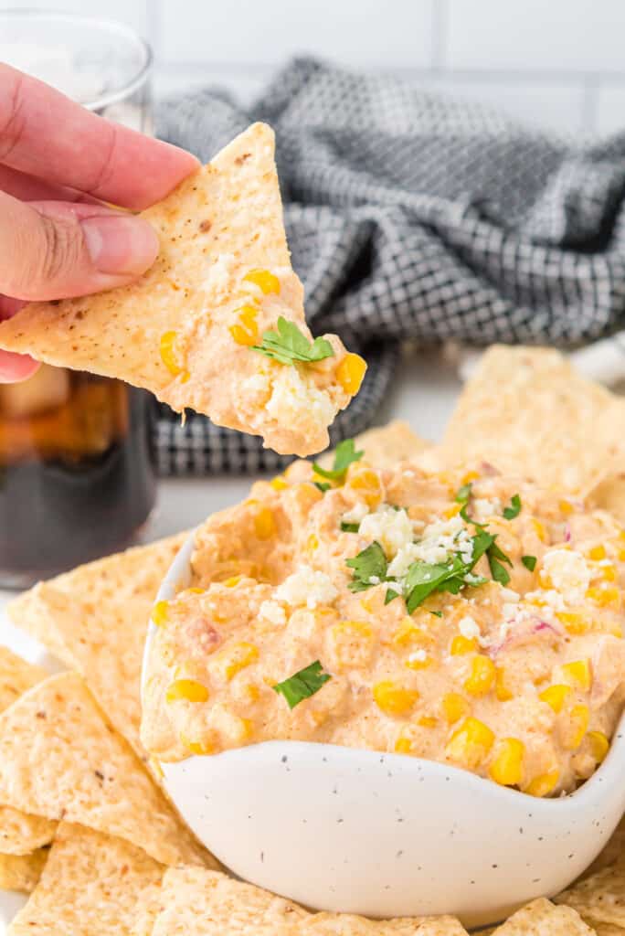 chip getting dipped into the corn dip recipe