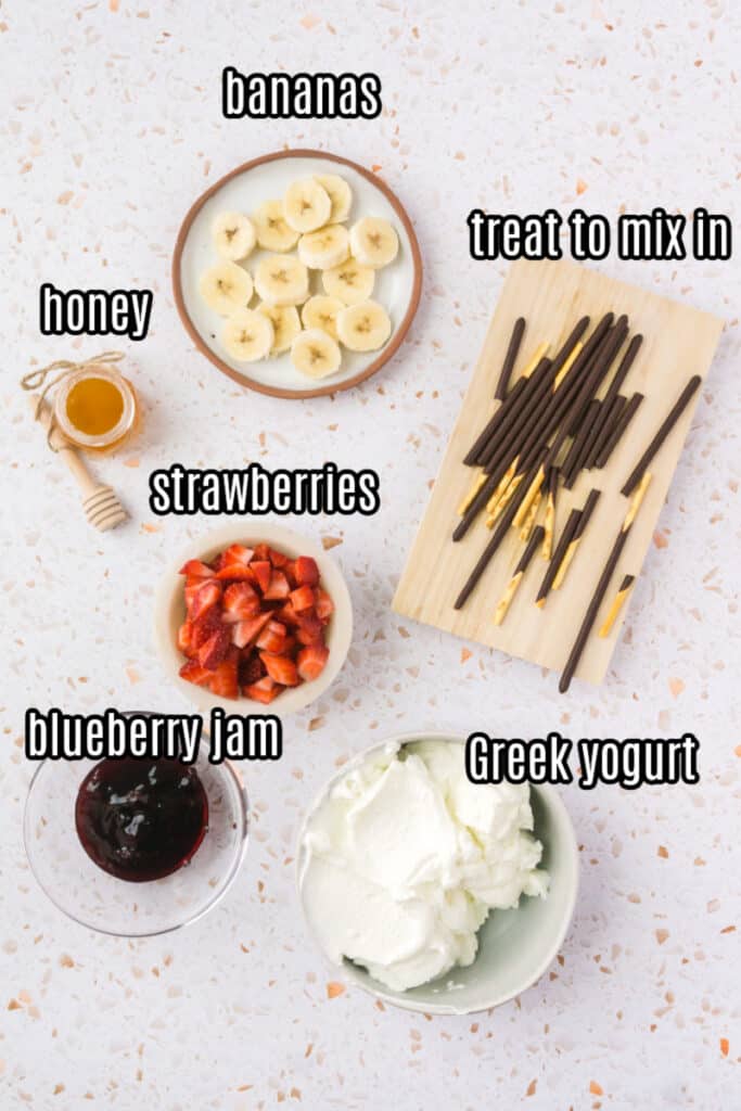 frozen yogurt bark ingredients on a light pink background