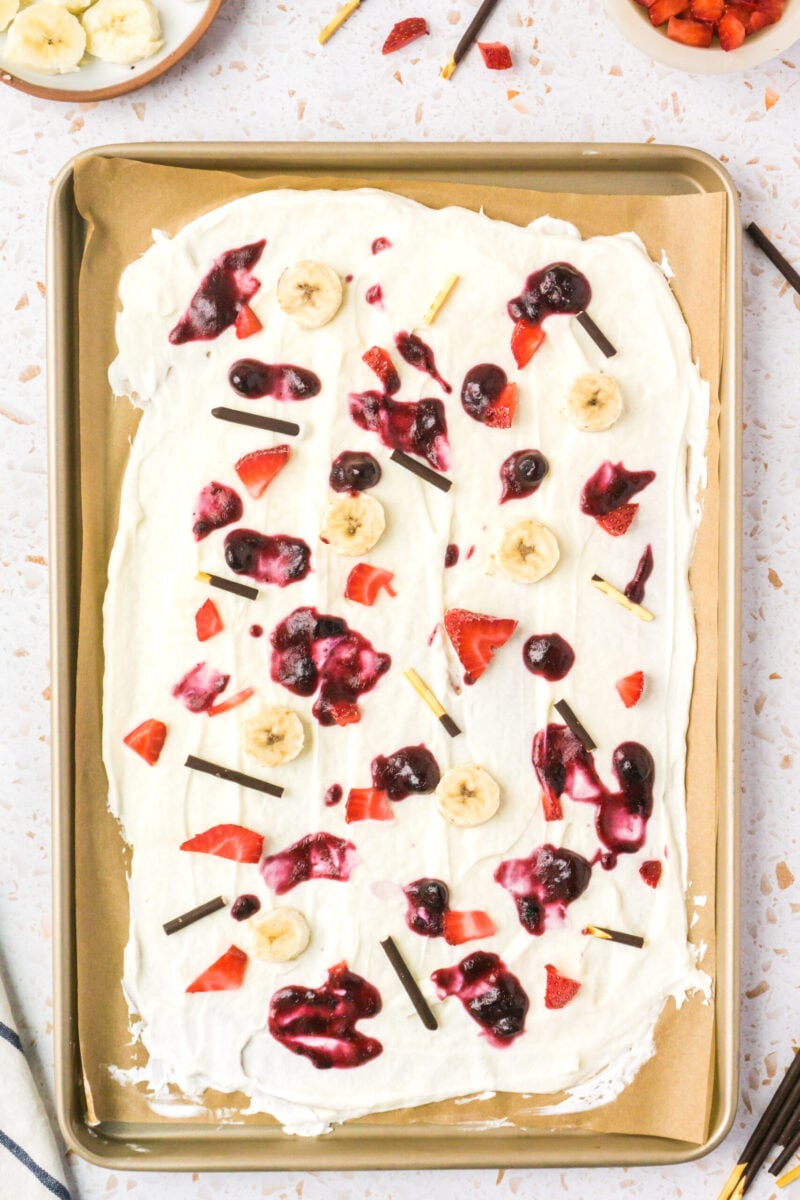 add toppings to the frozen yogurt bark 
