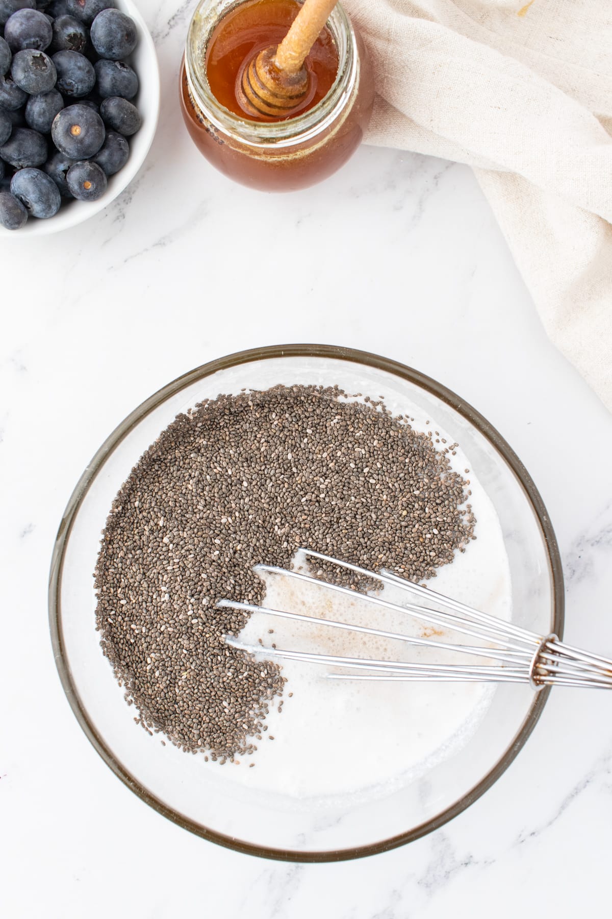 combining ingredients in a bowl for healthy chia puddings